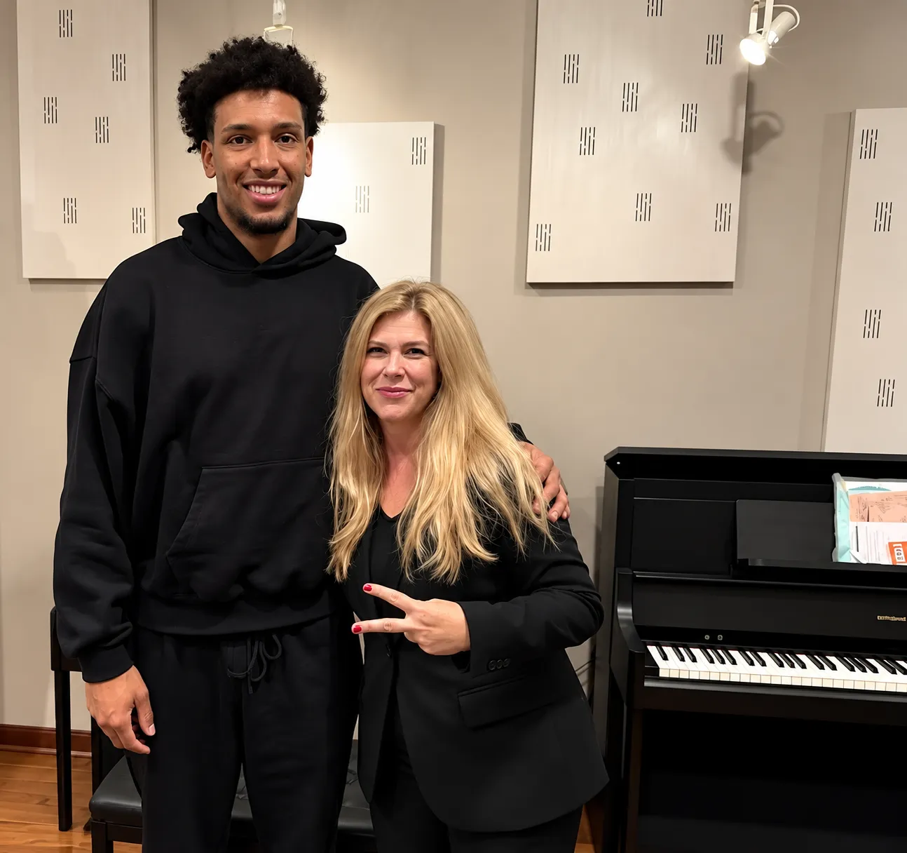 Northwestern Wildcats basketball player Luke McEldon with Michelle Henson at Grand Piano Haus beside his Roland LX digital piano